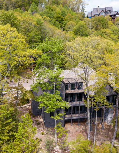 An aerial view of a home in the woods.