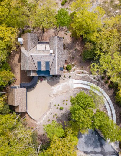 An aerial view of a house surrounded by trees.