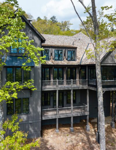 An aerial view of a home in the woods.