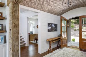 A hallway with wooden beams and a wooden door.