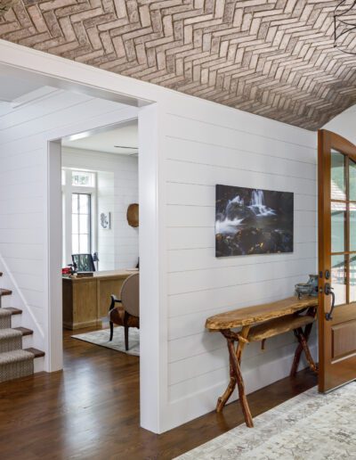 A hallway with wooden beams and a wooden door.