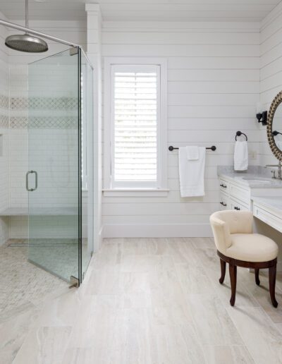A white bathroom with a glass shower stall.