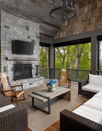 A living room with a fireplace and wicker furniture.