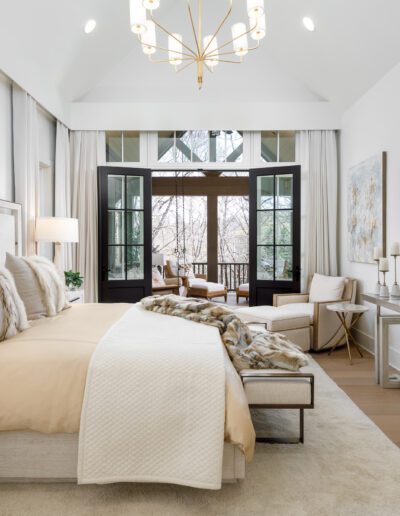 A bedroom with a large bed and a tv.