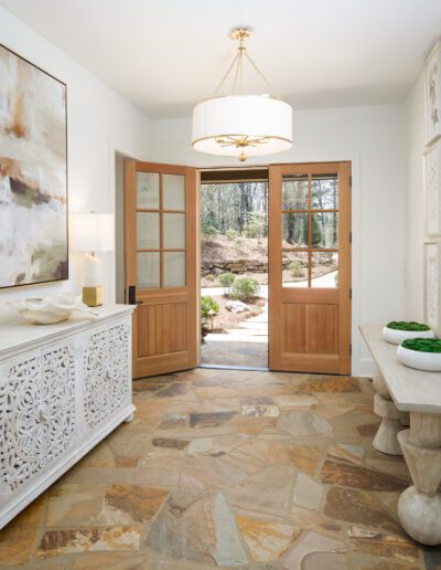 A hallway with a table and chairs.