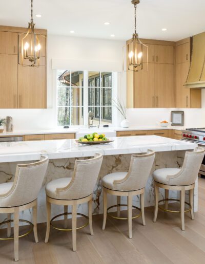 A kitchen with a center island and bar stools.