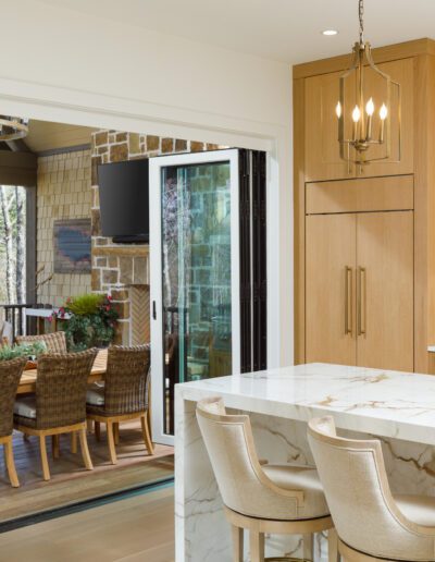 A kitchen with a dining table and chairs.