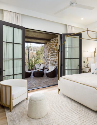 A bedroom with a king size bed and sliding glass doors.