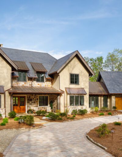 A home with a stone driveway and brick walkway.